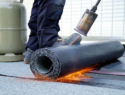 Close Up Of Rolled Roofing Being Installed with Propane Blowtorch