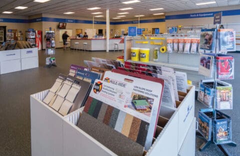 Interior of Solution Center with Sample Boards In Display Bins In The Foreground and a Desk in the Background